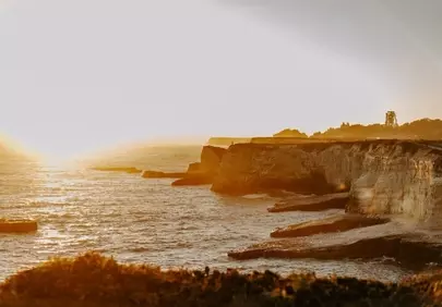 Golden Hour Majesty: Sunset over Dramatic Coastal Cliffs