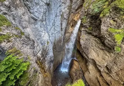 Majestic Alpine Waterfall Plunging Through Ancient Limestone