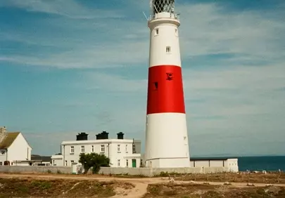Iconic Red-Banded Lighthouse Against a Vivid Blue Sky