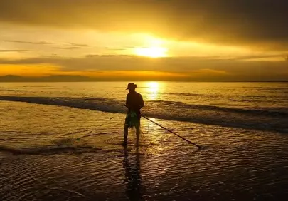 Golden Dawn: Fisherman's Solitude on the Vietnamese Coast