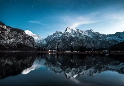 Stunning Alpine Night: Starry Sky Over Mirrored Lake