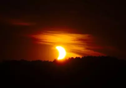 Breathtaking Solar Eclipse: Moon Veiling the Golden Sunset