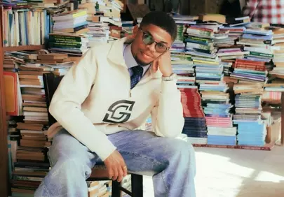 Stylish Young Man Lost in a Sea of Books