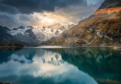 Dramatic Alpine Sunset Reflection: Serene Mountain Lake Views
