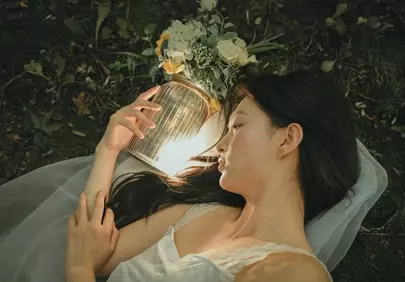 Enchanting Spring Twilight: Woman Amidst Glowing Flowers