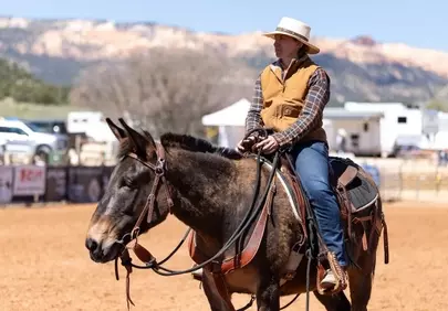 Rugged Beauty: Cowgirl & Mule in Western Landscape