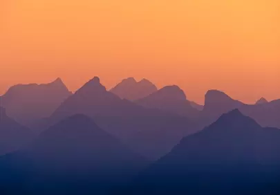 Breathtaking Mountain Alpenglow: Serene Sunset Silhouette