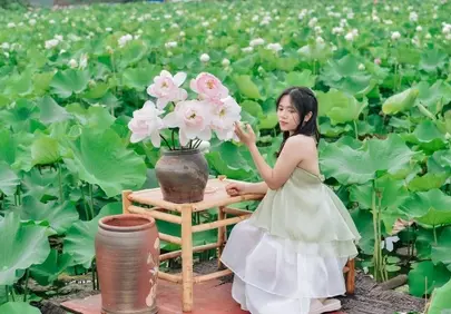 Serene Beauty: Woman Amidst Lush Lotus Garden
