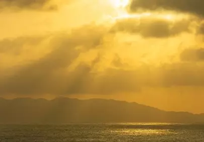 Dramatic Golden Sunset Over Calm Ocean Serenity