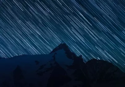 Celestial Symphony: Star Trails Over Majestic Mountains