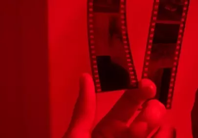Dramatic Red Light: Developing Film Strip in the Darkroom