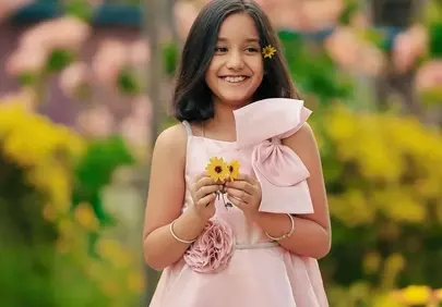 Joyful Child Amidst Blooming Flowers