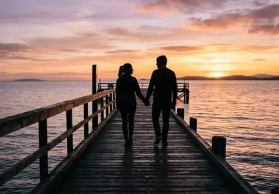 Romantic Sunset Stroll: Couple on a Golden Hour Pier