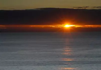 Breathtaking Ocean Sunset: Golden Rays Over Calm Seas