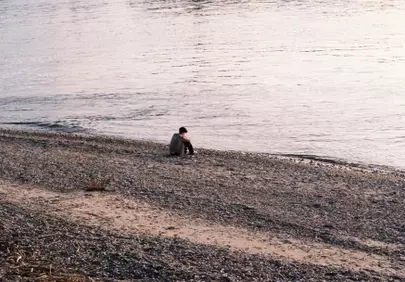 Solitude by the Shore: Reflective Moments on a Rocky Beach