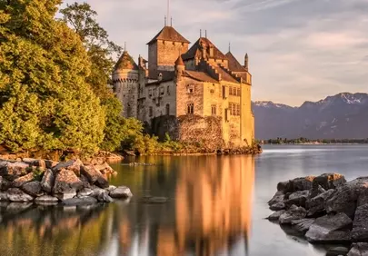 Enchanting Chillon Castle Sunset: Alpine Reflection on Lake Geneva