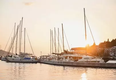 Golden Harbor Sunset: Yachts Bathed in Evening Glow