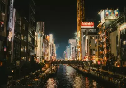Vibrant Nightscape: City Lights Dance on the Canal