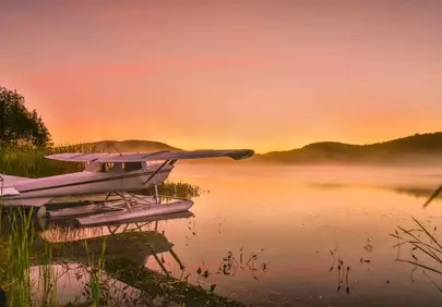 Breathtaking Autumn Dawn: Seaplane on a Tranquil Québec Lake