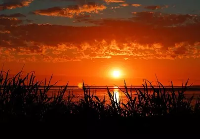 Fiery Horizon: Serene Sunset over North Sea Coast