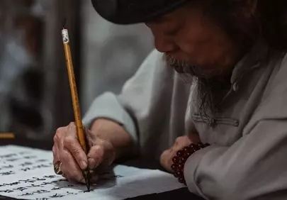 Timeless Asian Art: Elderly Man's Calligraphy Mastery