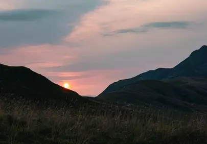 Breathtaking Autumn Sunset Over Serene Mountain Meadows