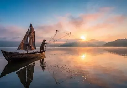 Breathtaking Dawn: Fisherman's Serene Morning Casting