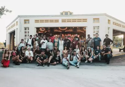 Vibrant Group Captures Joyful Moments by the Carousel