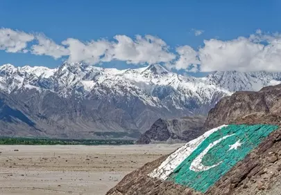 Majestic Karakoram: Pakistan Flag Adorns Snow-Capped Peaks