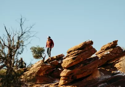 Rugged Ascent: Hiker Explores Rocky Terrain Under Clear Sky