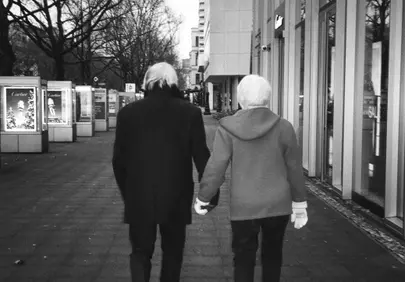 Timeless Love: Elderly Couple's Hand-in-Hand Stroll