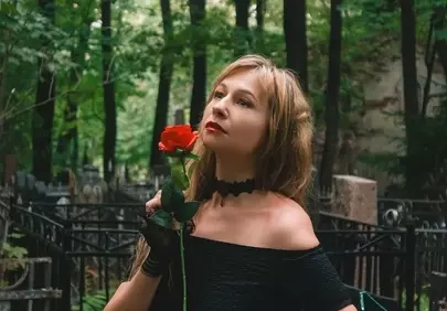 Enigmatic Gothic Beauty with a Red Rose in a Mystical Forest