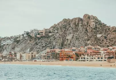 Vibrant Coastal Escape: Colorful Buildings Under Rocky Mountains