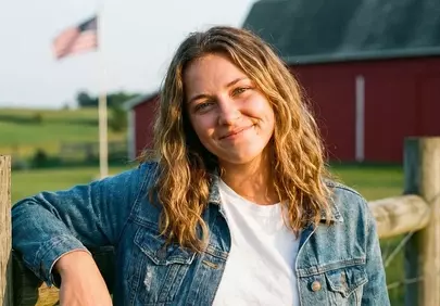 Rustic Charm: Smiling Woman on a Summer Farm