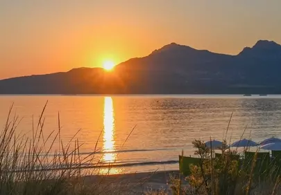 Breathtaking Corsica Sunrise: Golden Glow Over Tranquil Bay