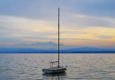Serene Sunset Sailboat on Tranquil Lake Waters
