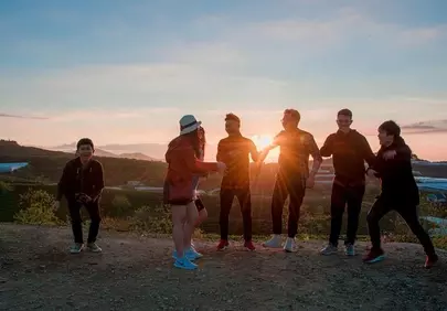 Vibrant Sunset Gathering: Friends Embrace Golden Hour
