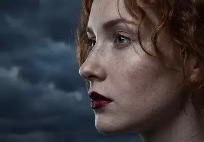 Fiery Spirit: Redhead Gazing into the Storm