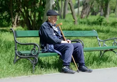 Serene Moment: Elderly Man Rests Peacefully in Spring Park