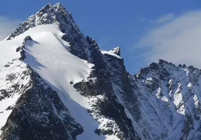 Breathtaking Alps: Majestic Snow-Capped Peak Under Blue Sky
