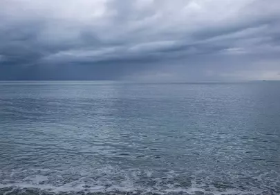 Serene Pebble Beach Under a Dramatic Grey Sky