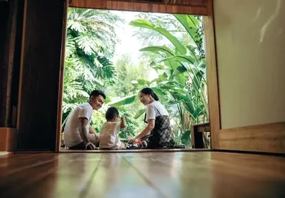 Joyful Family Moment: Parents & Child Embrace Nature's Bliss