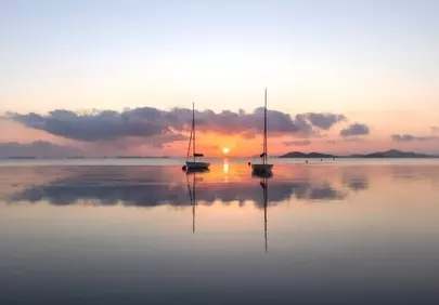 Serene Dawn: Two Boats Reflecting the Murcia Sunrise