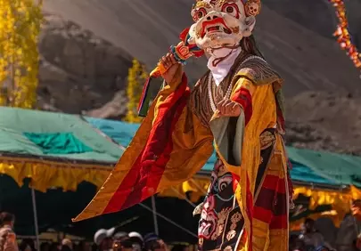 Vibrant Himalayan Dance: Masked Performer in Mountain Festival