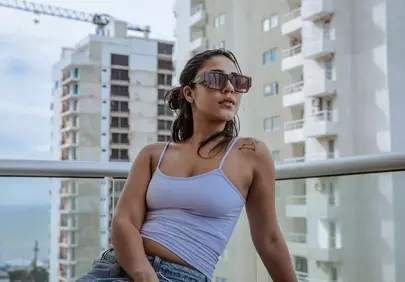 Miami Vibes: Stylish Woman Relaxes on Balcony with Ocean View