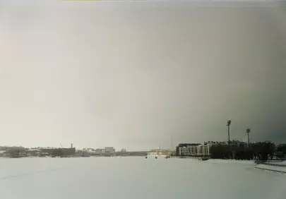 Ethereal Winterscape: Buildings Under Overcast Skies