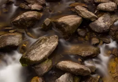 Serene Long Exposure: Misty Autumn River Rocks