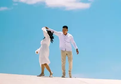 Joyful Couple Dancing Under a Clear Summer Sky