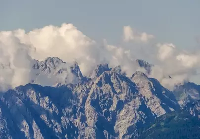 Majestic Alpine Peaks Crowned by Whispering Clouds