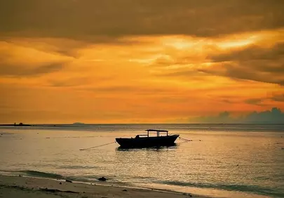 Breathtaking Sunset Serenity: A Lone Boat on the Horizon